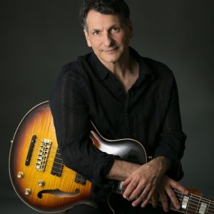 John Patitucci playing bass guitar on stage